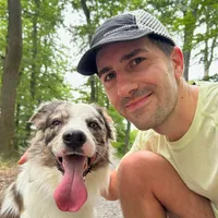 Samuel Molnar and a dog on a forest trail